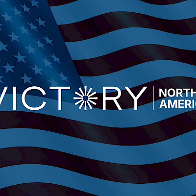 Victory North America logo, USA state flag in the background with Victory Lighting blue overlay